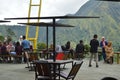 visitors to a cafe are resting and enjoying the view of the green hills in the Sembalun area of Ã¢â¬â¹Ã¢â¬â¹the Mount Rinjani